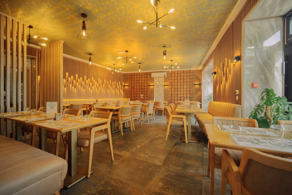 Restaurant dining room with wood tables and warm lighting