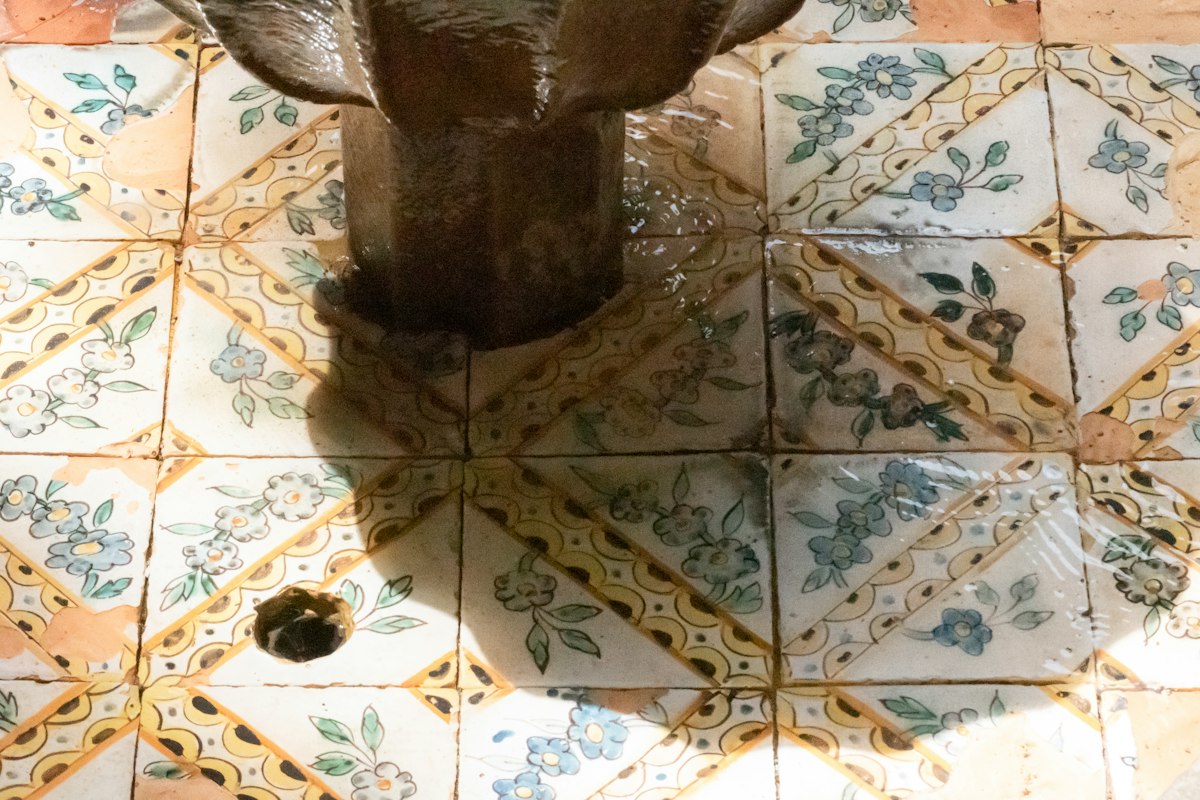 Fountain set into a patterned tile floor