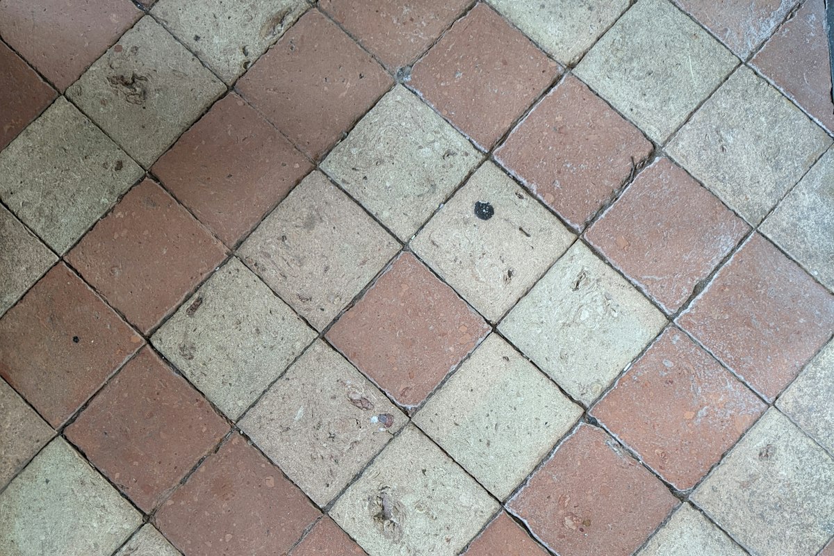 Terracotta and pale stone tiles laid in a diagonal pattern